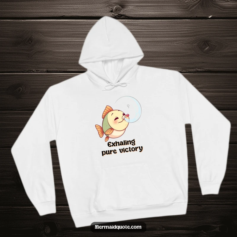 Funny determined fish hoodie showing a small fish expelling a large, perfect bubble, symbolizing effort and success, perfect for chilly days.
