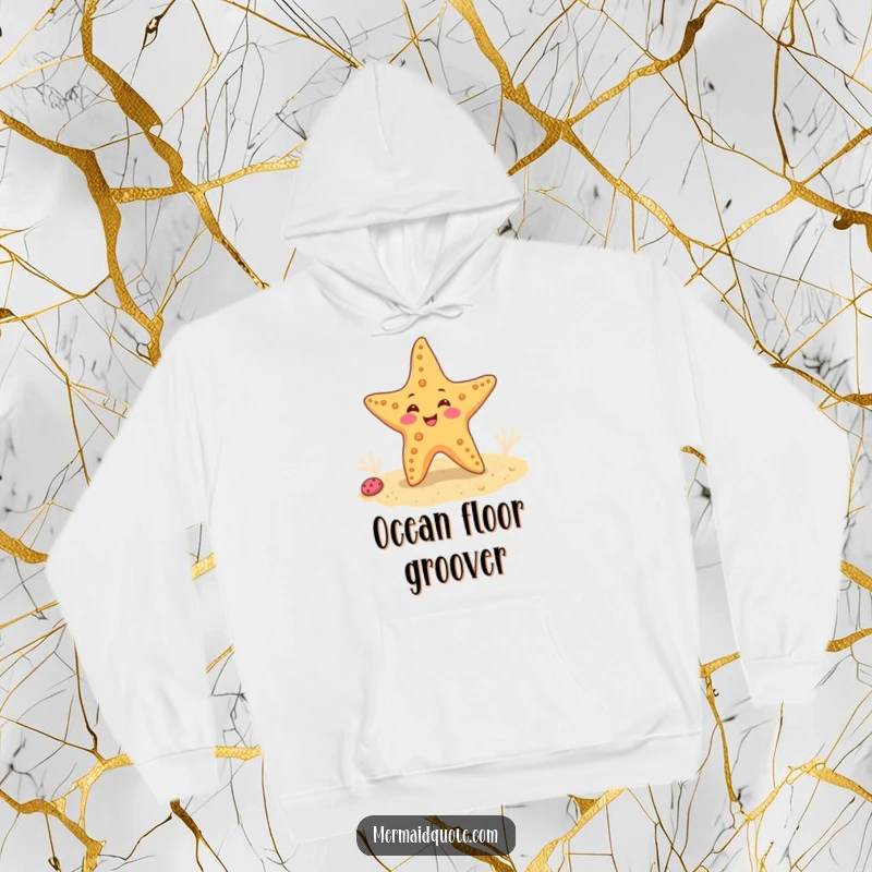 Funny hoodie illustrating a happy starfish doing a funny wiggle dance on a sandy ocean floor, offering cozy seaside fun.