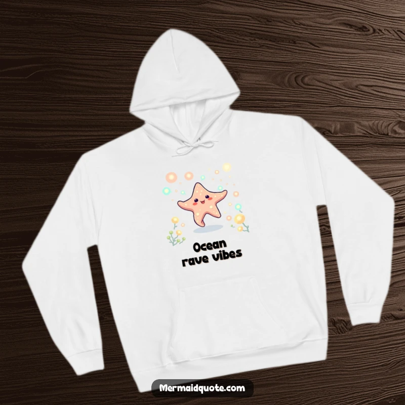 Funny, warm hoodie showing a cheerful starfish creature dancing amongst bioluminescent plankton. A glowing and cozy design.