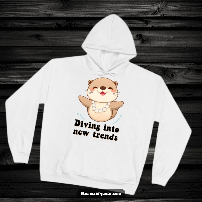 Funny happy sea otter wearing a pearl necklace, swimming with pure delight, depicted on a warm and cozy hoodie.