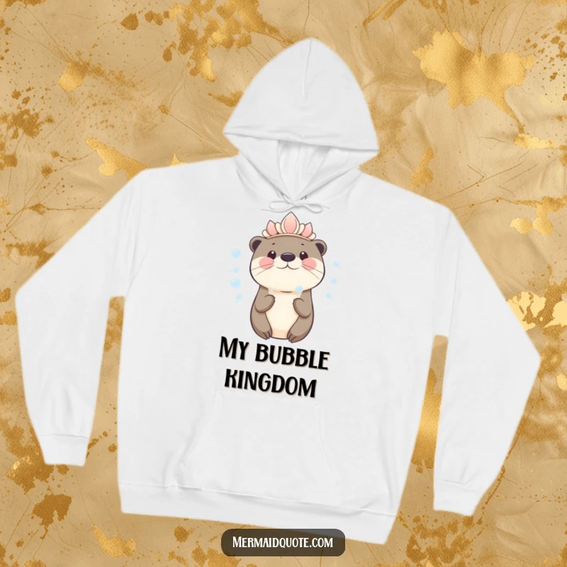 Funny kawaii otter wearing a seashell crown blowing bubbles on a hoodie, soft and cozy with charming art.