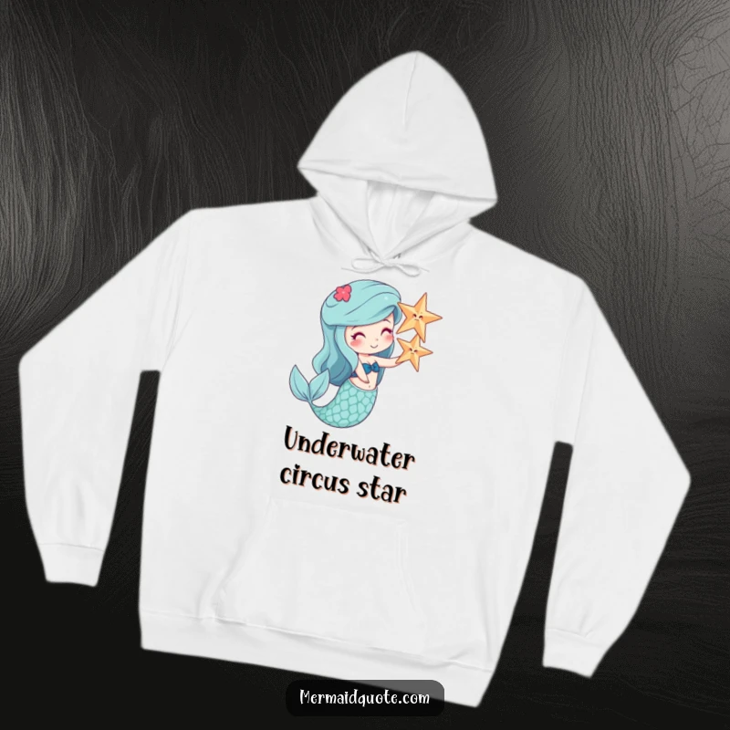 Funny hoodie depicting a cheerful mermaid balancing a starfish on her nose, perfect for cozy comedy.