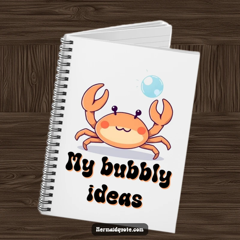 Funny tiny crab playfully waving its tiny claws at a bubble, a humorous notebook for jotting down beachy ideas.
