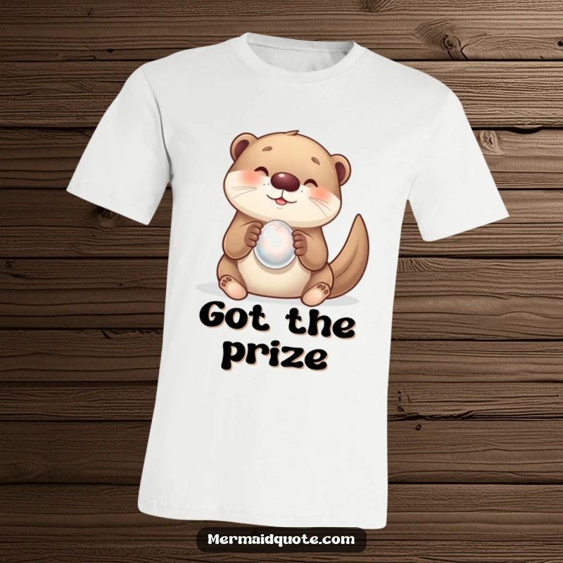 Funny t-shirt featuring a curious otter with a wide, delighted smile holding a shiny pearl. Whimsical animal art.