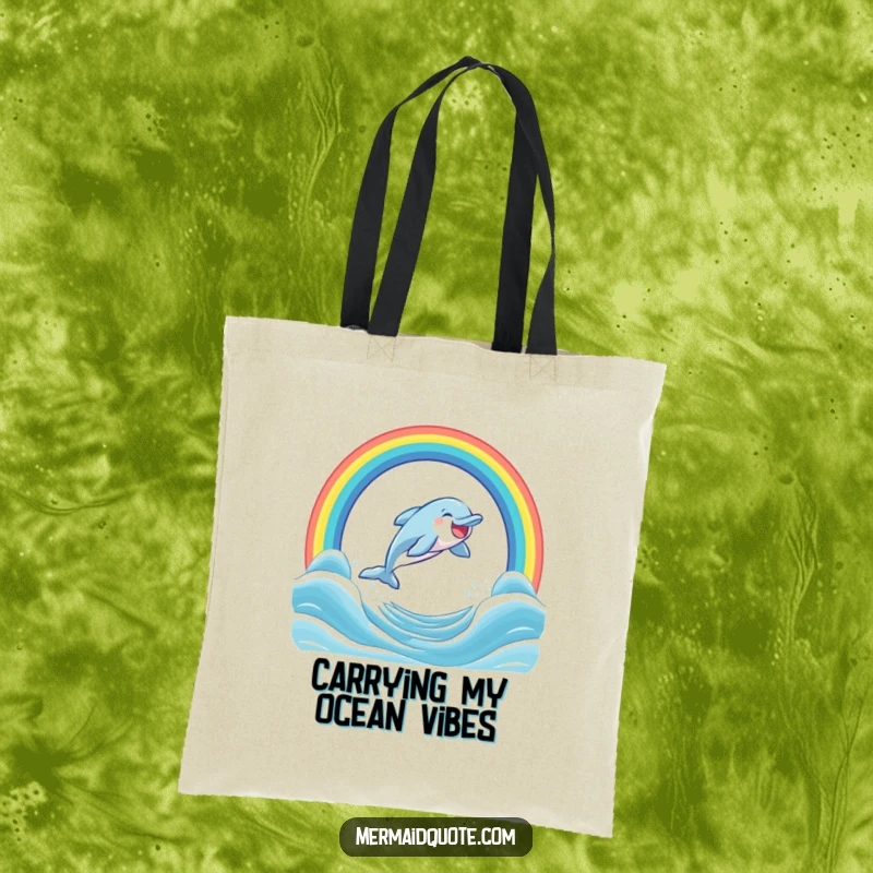 Funny tote bag showcasing a laughing dolphin artistically leaping through a vibrant rainbow arch in the sea, full of glee.